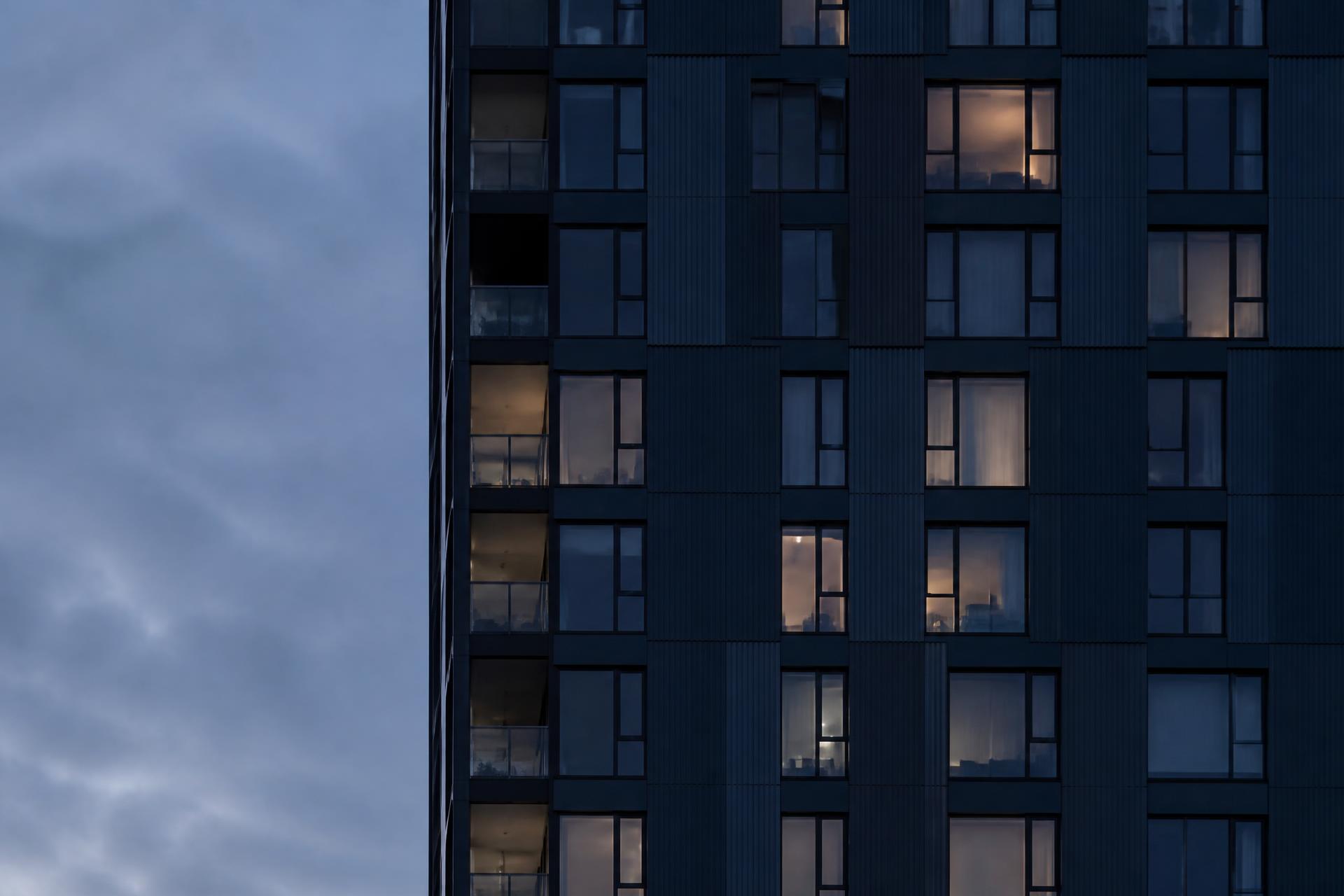 Modern residential tower facade at dusk